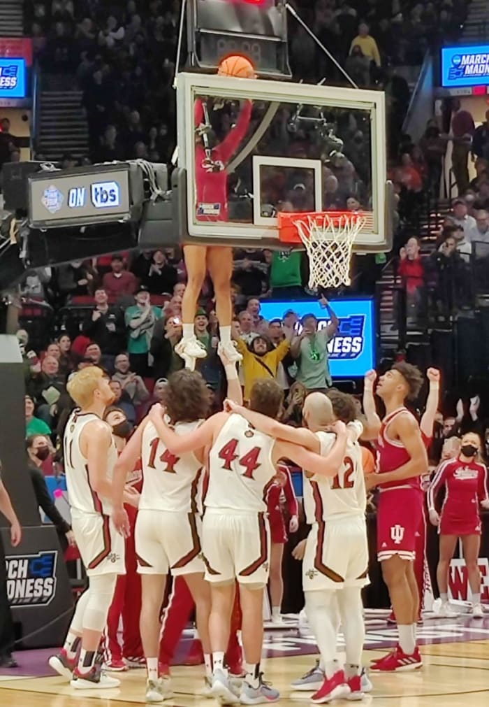 Indiana cheerleader Cassidy Cerny grabs the ball off the top of the backboard.